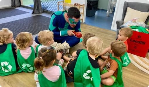 Man In Cape Playing With Kids — Early Learning in Highfields, QLD